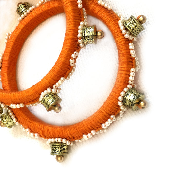 Pair of orange thread work beaded bangles - Aesthetics Designer Label